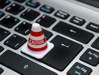 risk assessments gloabl training solutions laptop with safety cone