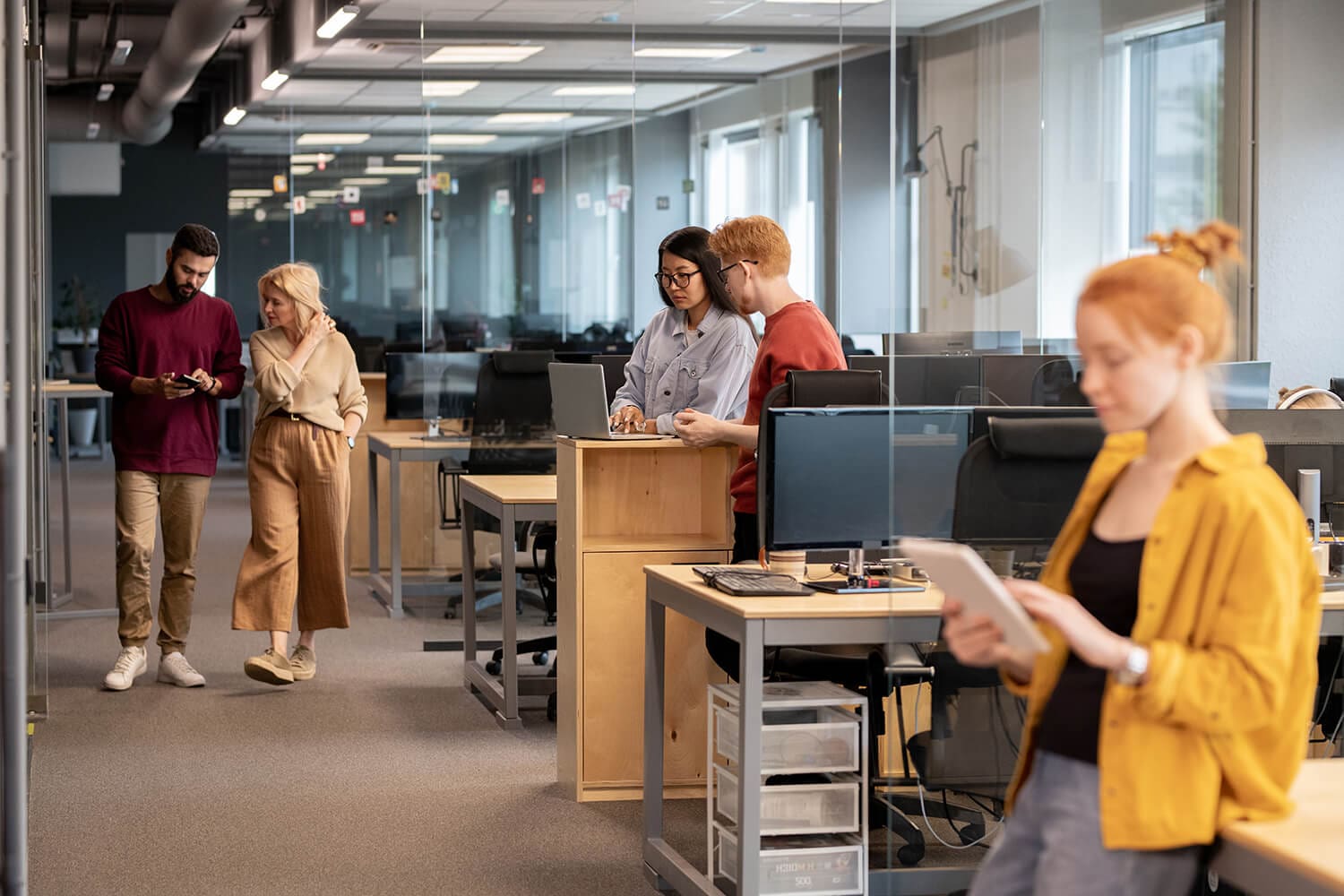 Health and safety professionals reviewing compliance documents in a modern office