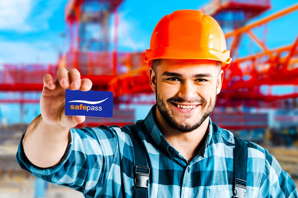Construction worker holding Safe Pass card on site in Ireland